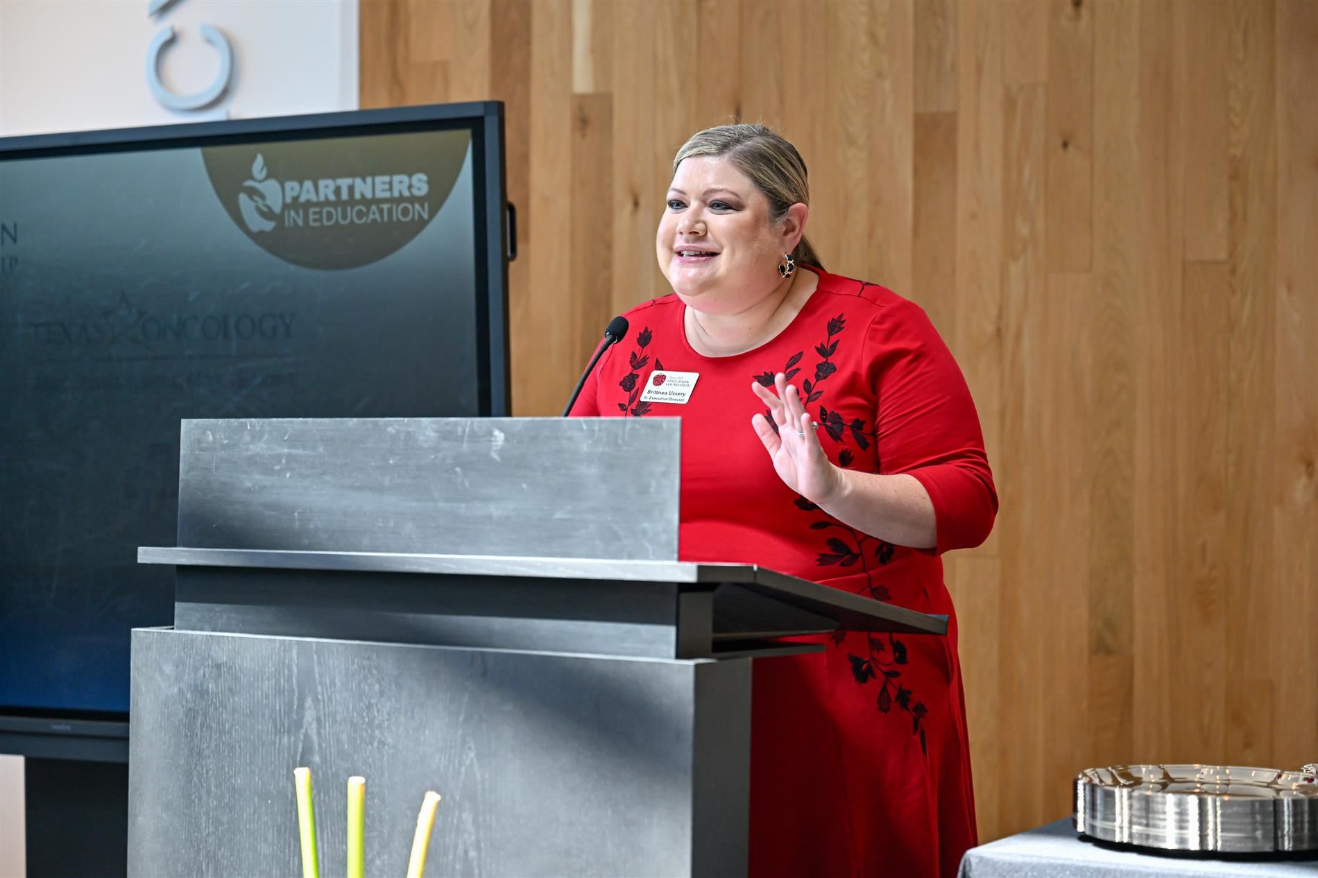 Education Foundation Executive Director Brittnea Ussery speaking at the podium